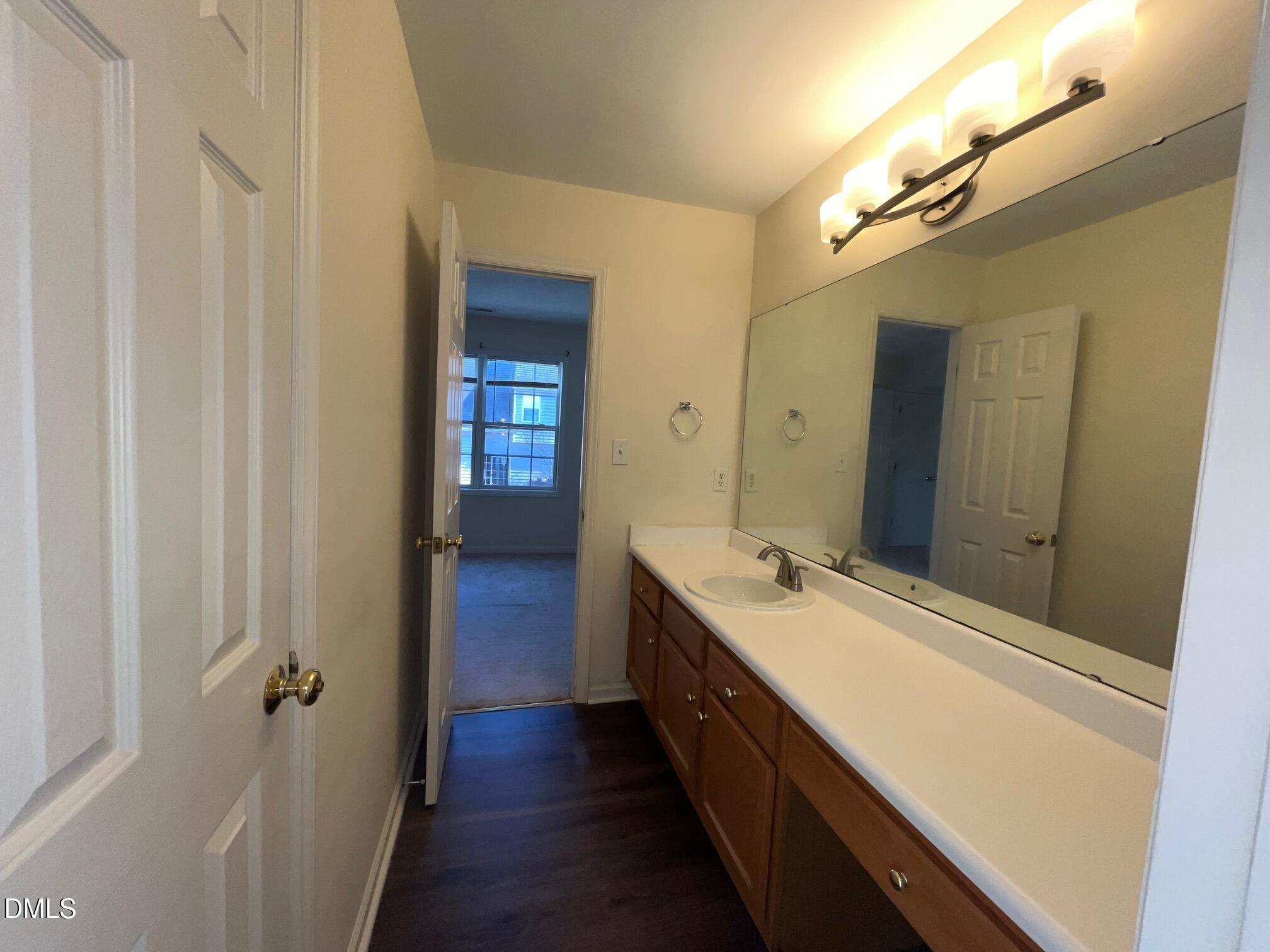 2604 Farlow Gap Lane Raleigh, NC 27603 - Photo 24 of 28 a spacious bathroom with a double vanity sink and a mirror