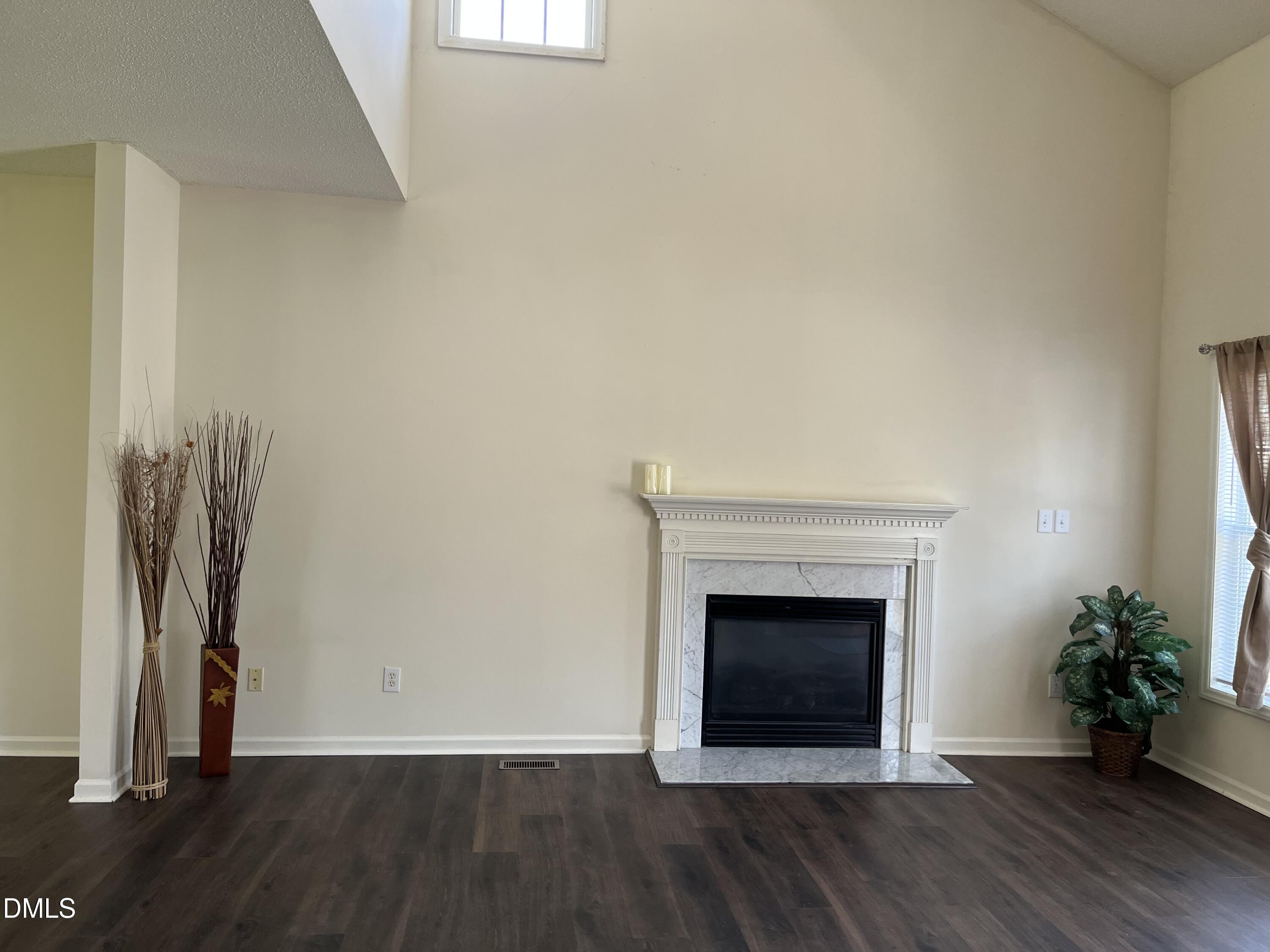 2604 Farlow Gap Lane Raleigh, NC 27603 - Photo 6 of 28 an empty room with wooden floor and a fireplace