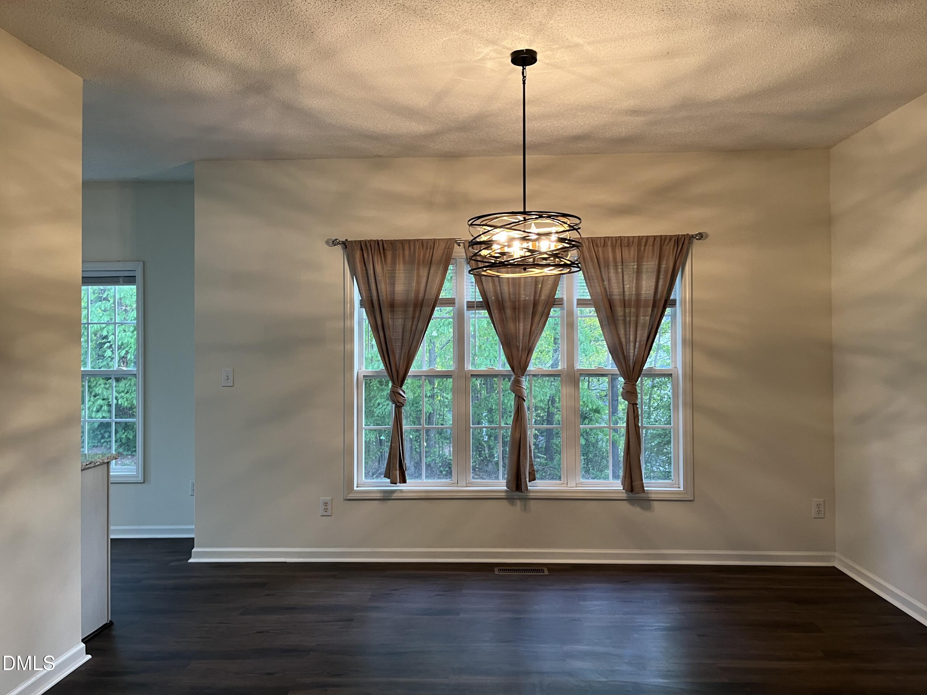 2604 Farlow Gap Lane Raleigh, NC 27603 - Photo 9 of 28 a view of empty room with wooden floor and windows