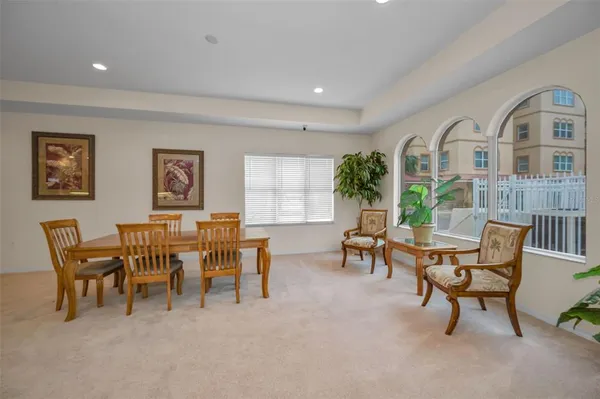 a large kitchen with granite countertop a sink and white cabinets