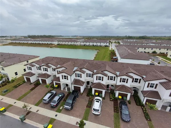 an aerial view of a house with outdoor space and lake view