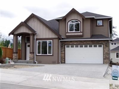 3828 222nd Place Southeast Bothell, WA 98021 - Photo 1 of 1 a front view of a house with a yard and garage