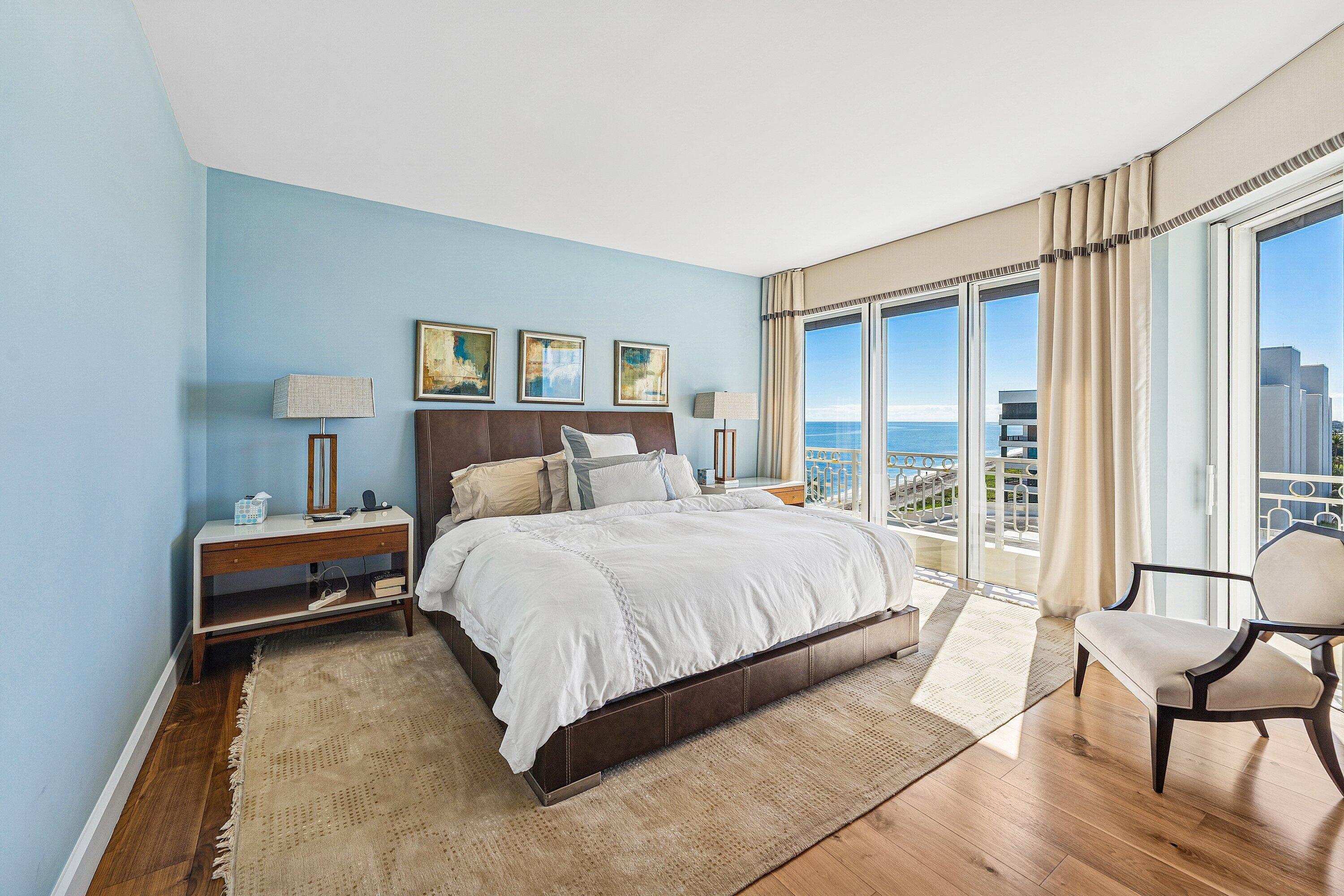 19950 South Beach Road, Unit 7S Jupiter, FL 33469 - Photo 15 of 40 a bedroom with a bed a chair and a large window