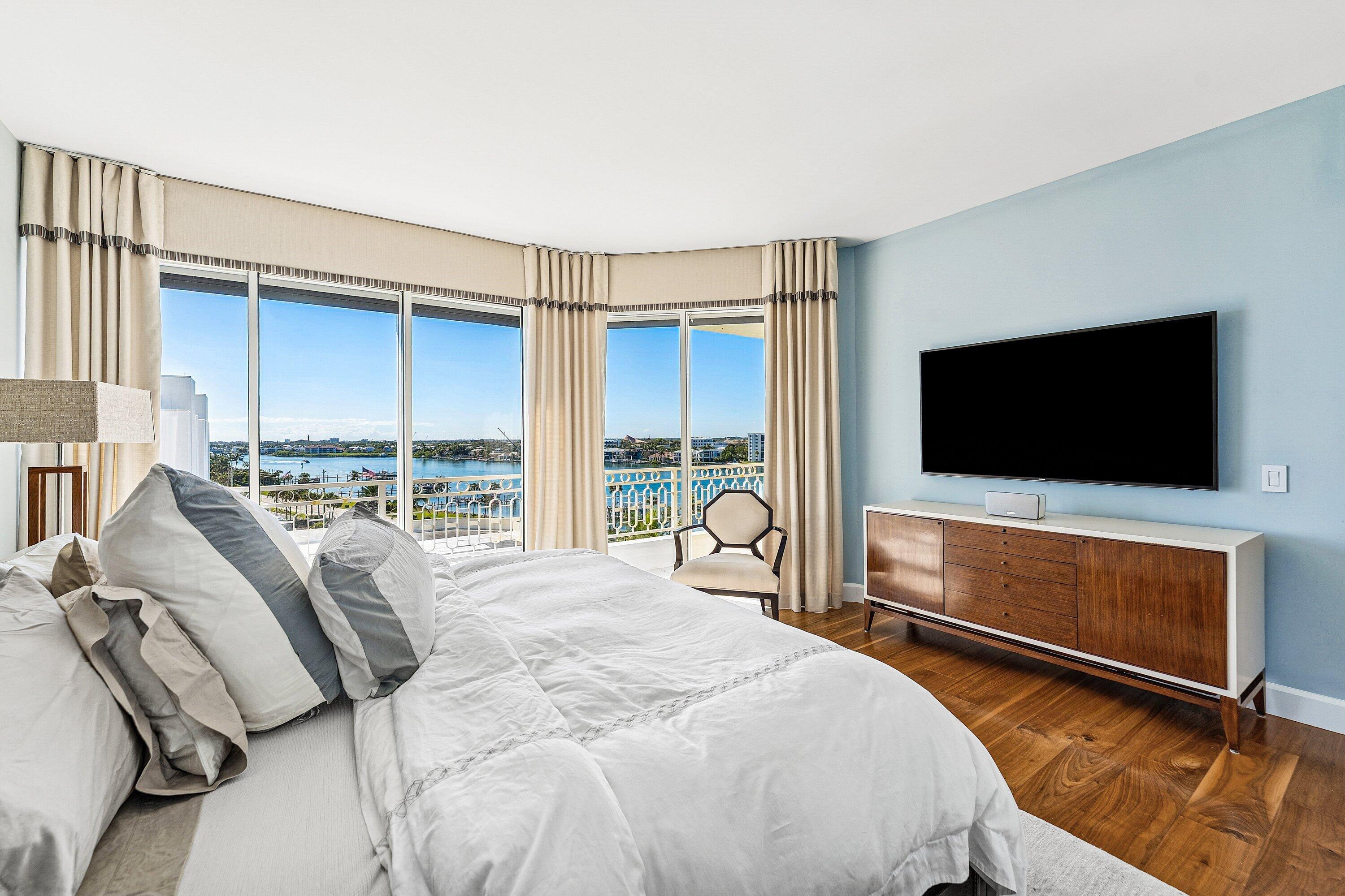 19950 South Beach Road, Unit 7S Jupiter, FL 33469 - Photo 16 of 40 a bed room with a bed and a television