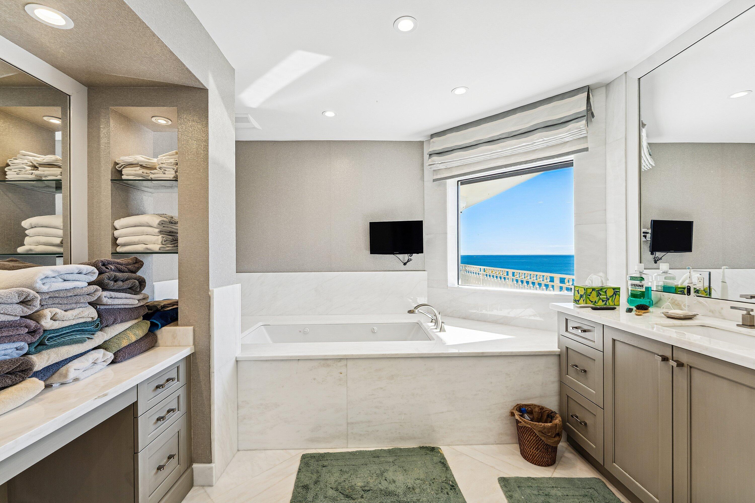 19950 South Beach Road, Unit 7S Jupiter, FL 33469 - Photo 22 of 40 a bathroom with a double vanity sink mirror and