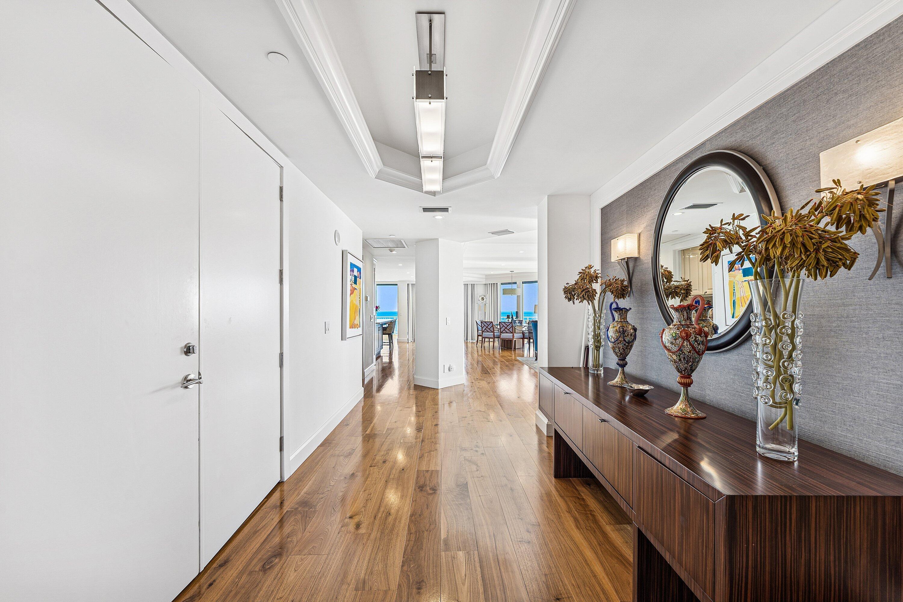 19950 South Beach Road, Unit 7S Jupiter, FL 33469 - Photo 5 of 40 a view of a hallway with wooden floor and stairs