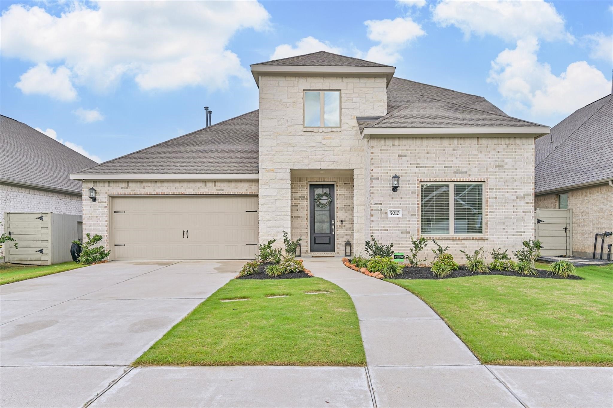 5010 Walnut Grv Lane Manvel, TX 77578 - Photo 1 of 46 a front view of a house with a yard and garage
