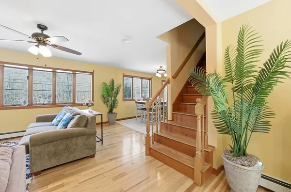 a living room with furniture and a potted plant
