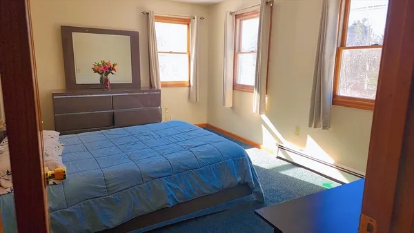a bed sitting in a bedroom next to a window