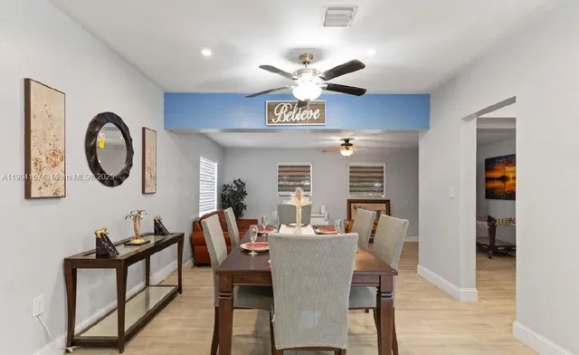 a view of a dining room with furniture and a chandelier