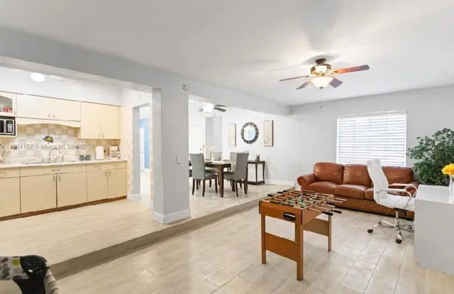 a living room with furniture two night stand and a window