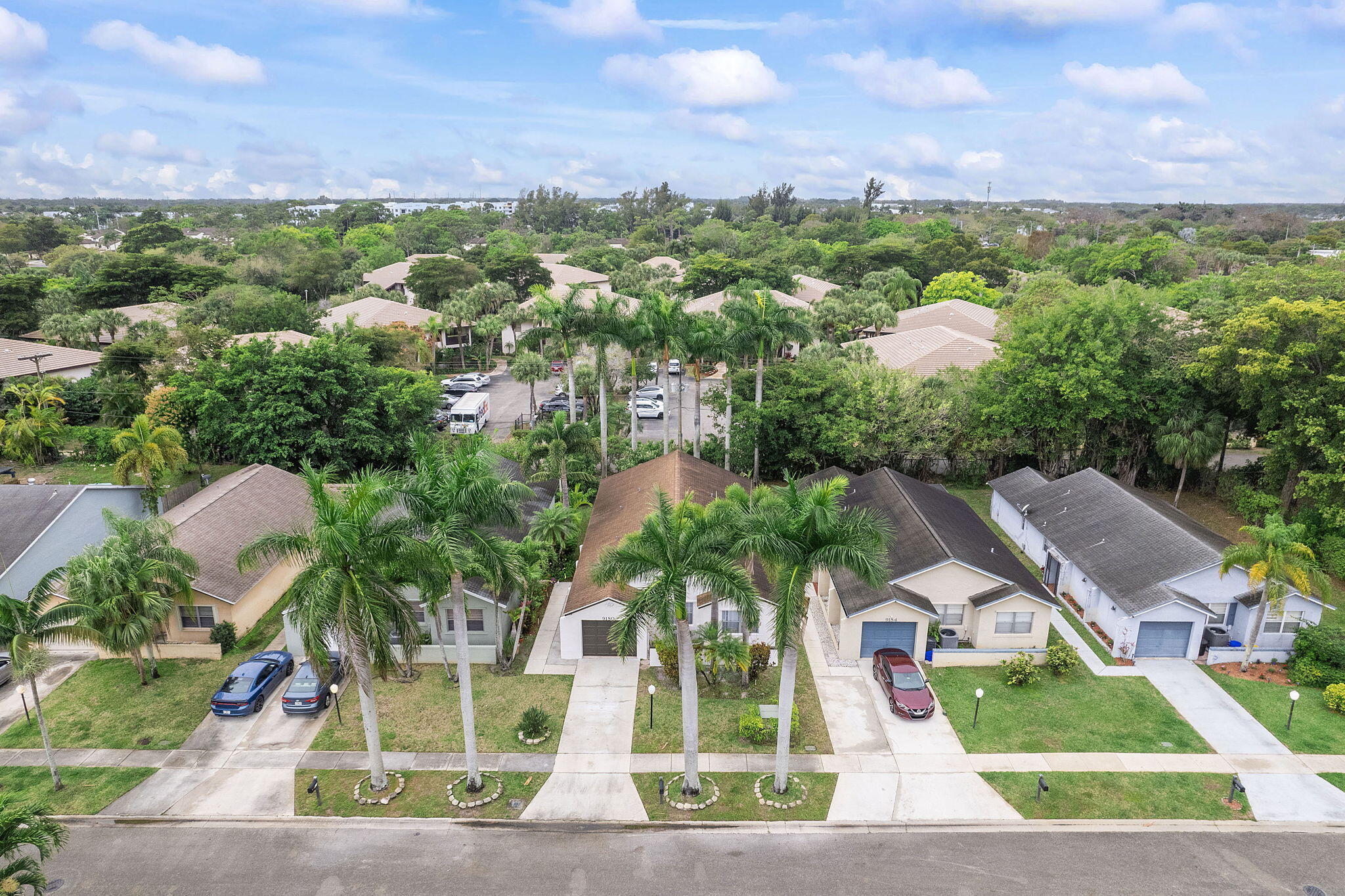 9180 Pine Springs Drive Boca Raton, FL 33428 - Photo 29 of 29 a view of a house with a yard and sitting area