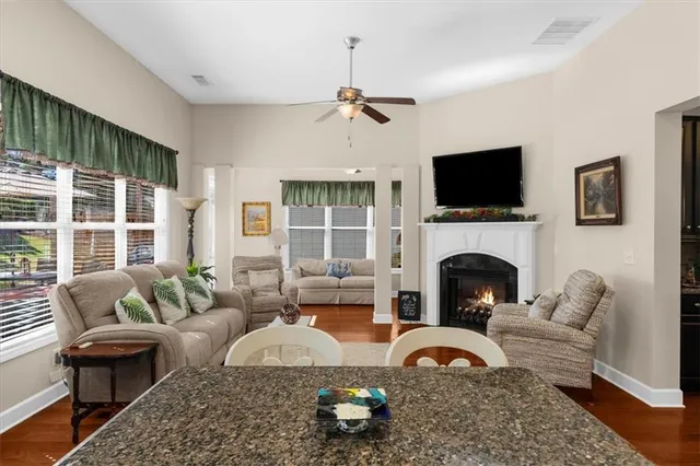 a living room with furniture a fireplace and a flat screen tv