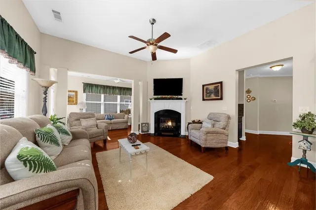 a living room with furniture fireplace and a large window