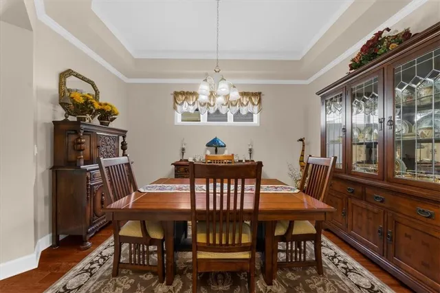 a view of a dining room with furniture and chandelier