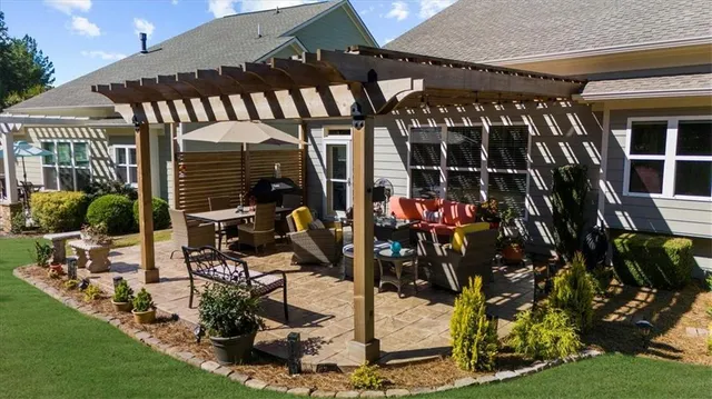 a view of a house with yard and sitting area