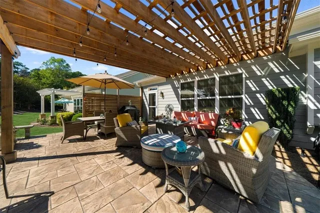 a view of a patio with table and chairs and potted plants