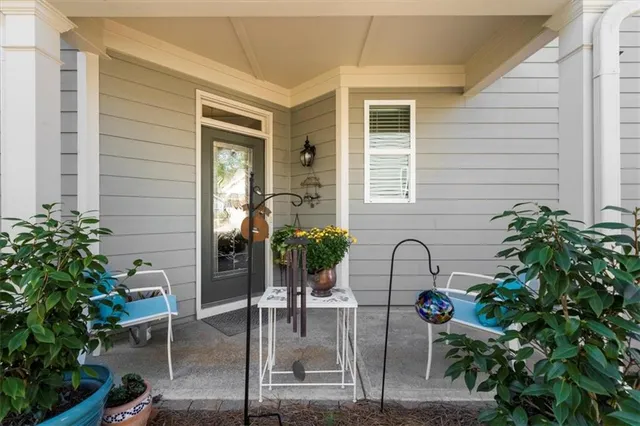 a house view with a potted plant in front of it