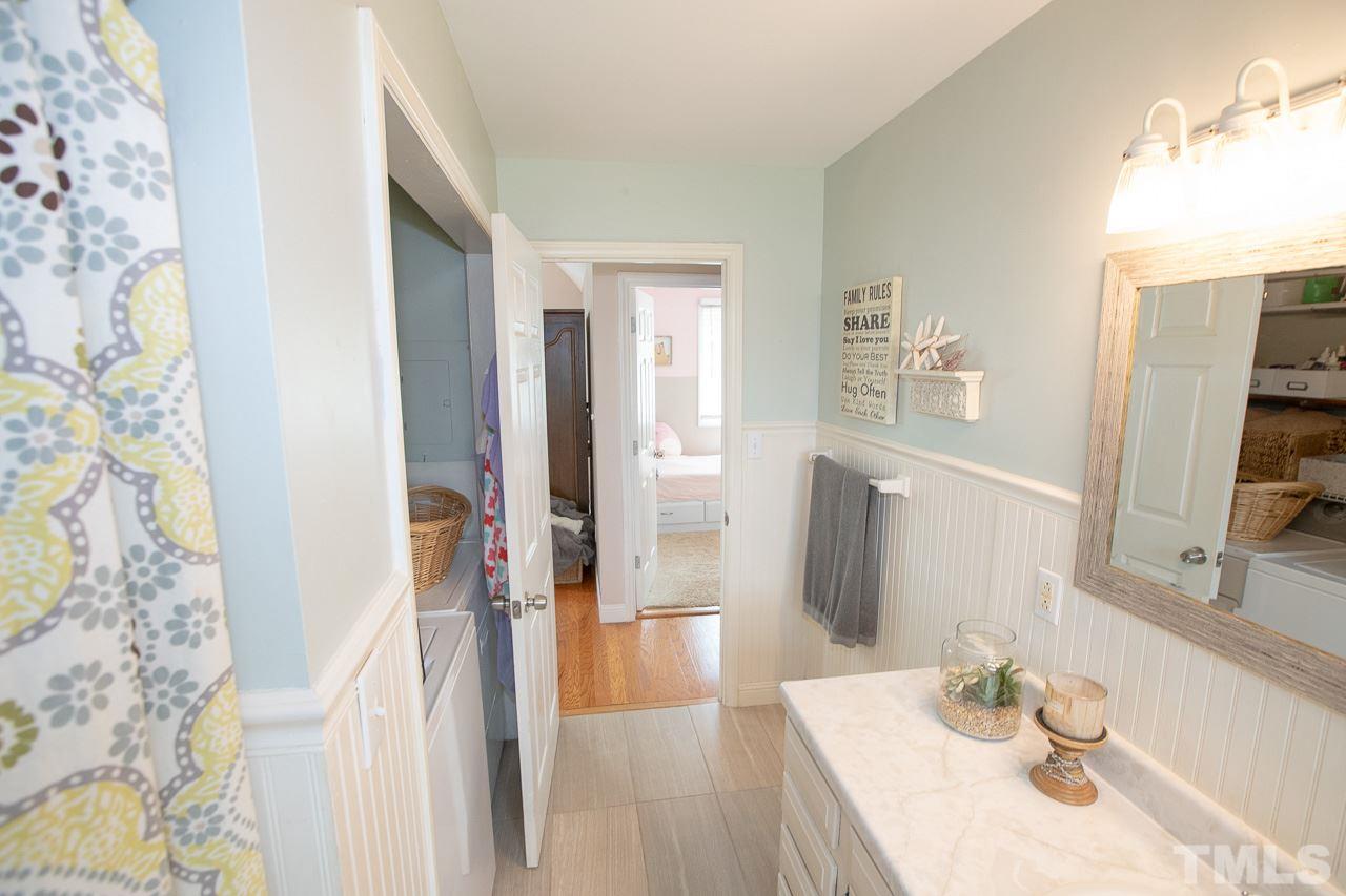 11213 Crestmont Drive Raleigh, NC 27613 - Photo 14 of 30 a bathroom with a sink and a mirror