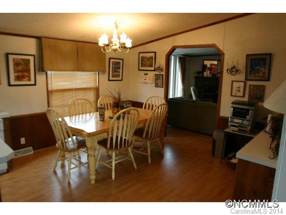 1298 Grassy Knob Road Rutherfordton, NC 28139 - Photo 10 of 18 a dining room with furniture a chandelier and wooden floor
