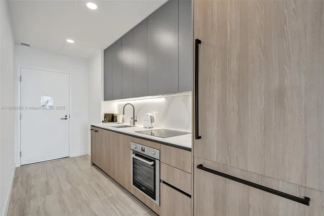a kitchen with stainless steel appliances granite countertop a sink and cabinets