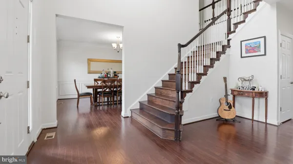 a large kitchen with stainless steel appliances kitchen island granite countertop a sink a stove and cabinets