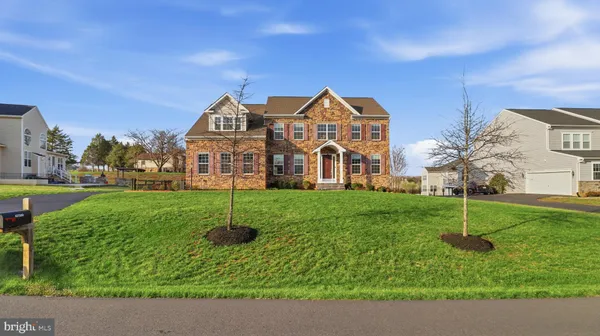 an aerial view of a house with garden space lake view and mountain view in back