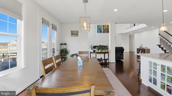 a view of a livingroom with wooden floor and staircase