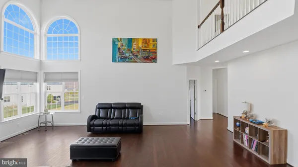 a bedroom with furniture and a wooden floor