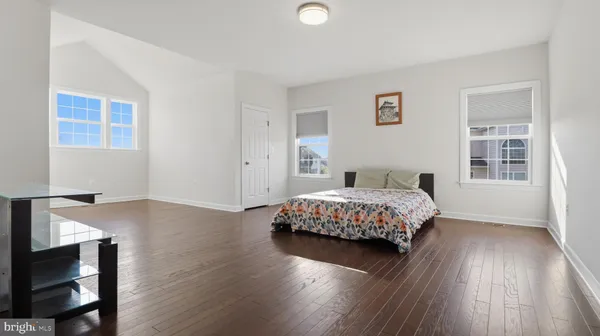 a view of a roof deck with table and chairs a barbeque with wooden floor and fence