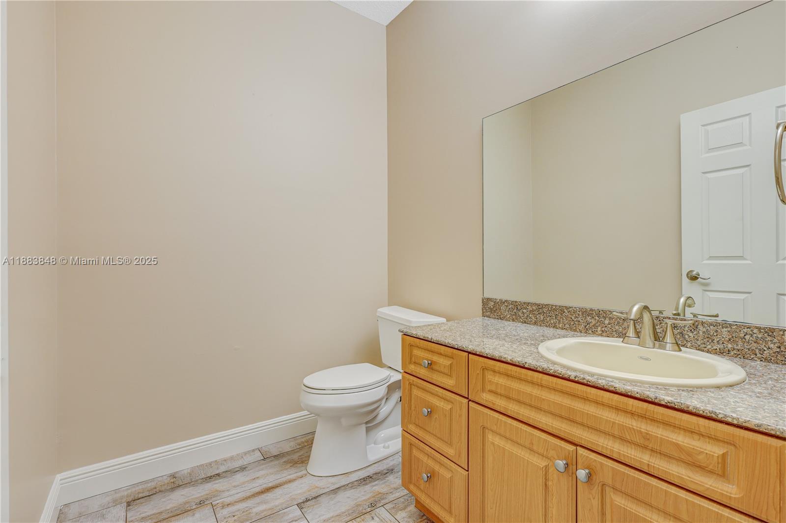 7627 East Stonecreek Circle Davie, FL 33024 - Photo 12 of 29 a bathroom with a granite countertop toilet and sink