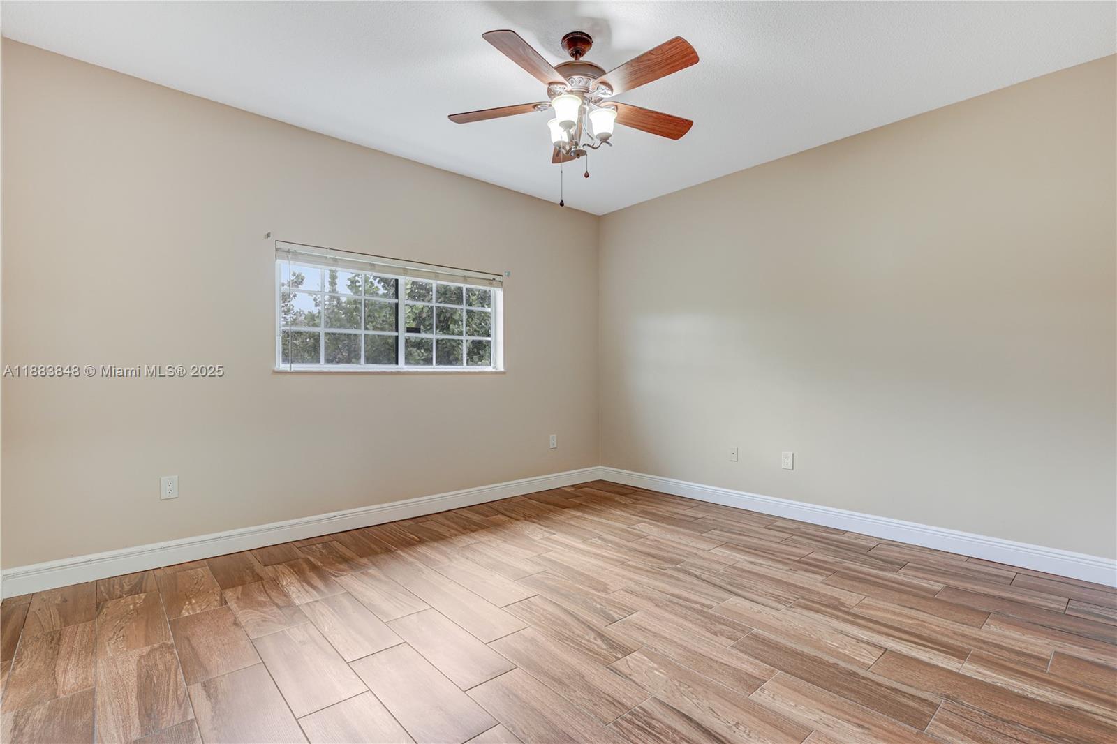 7627 East Stonecreek Circle Davie, FL 33024 - Photo 13 of 29 wooden floor in an empty room with a window