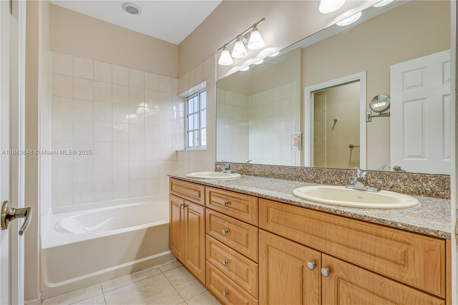 7627 East Stonecreek Circle Davie, FL 33024 - Photo 17 of 29 a bathroom with a granite countertop sink mirror and a