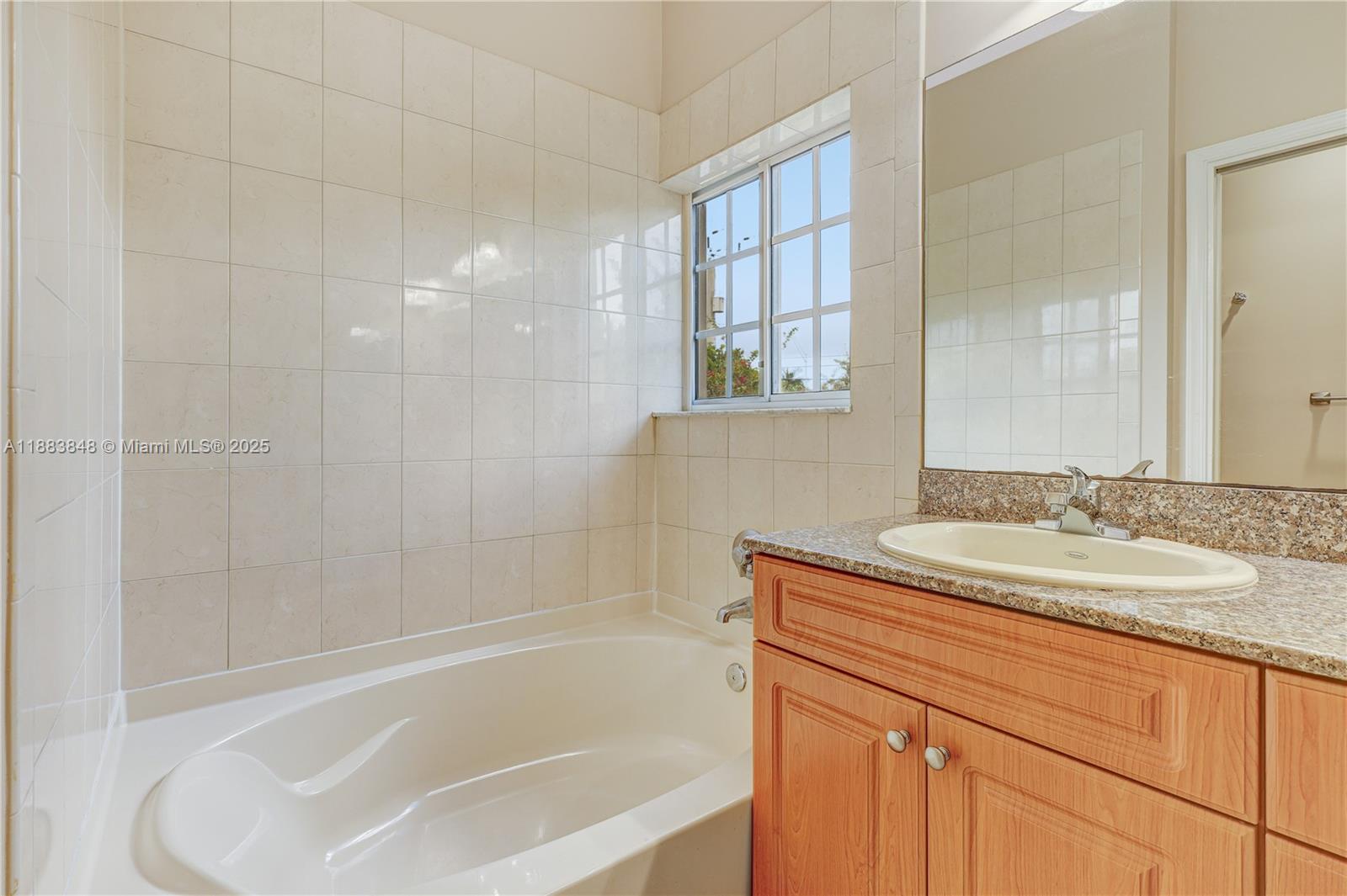 7627 East Stonecreek Circle Davie, FL 33024 - Photo 18 of 29 a bathroom with a sink and a bathtub