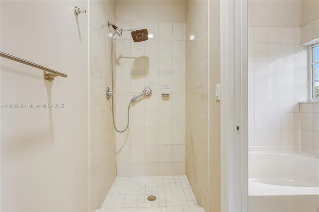 a bathroom with a glass shower door