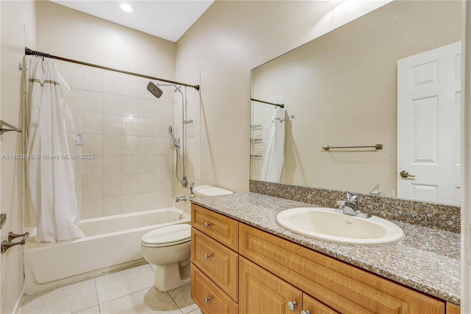 7627 East Stonecreek Circle Davie, FL 33024 - Photo 22 of 29 a bathroom with a granite countertop sink toilet and shower