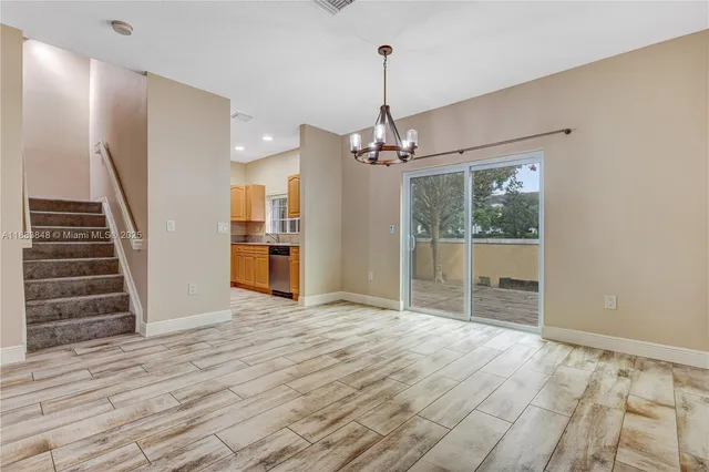 a view of empty room with wooden floor and stove