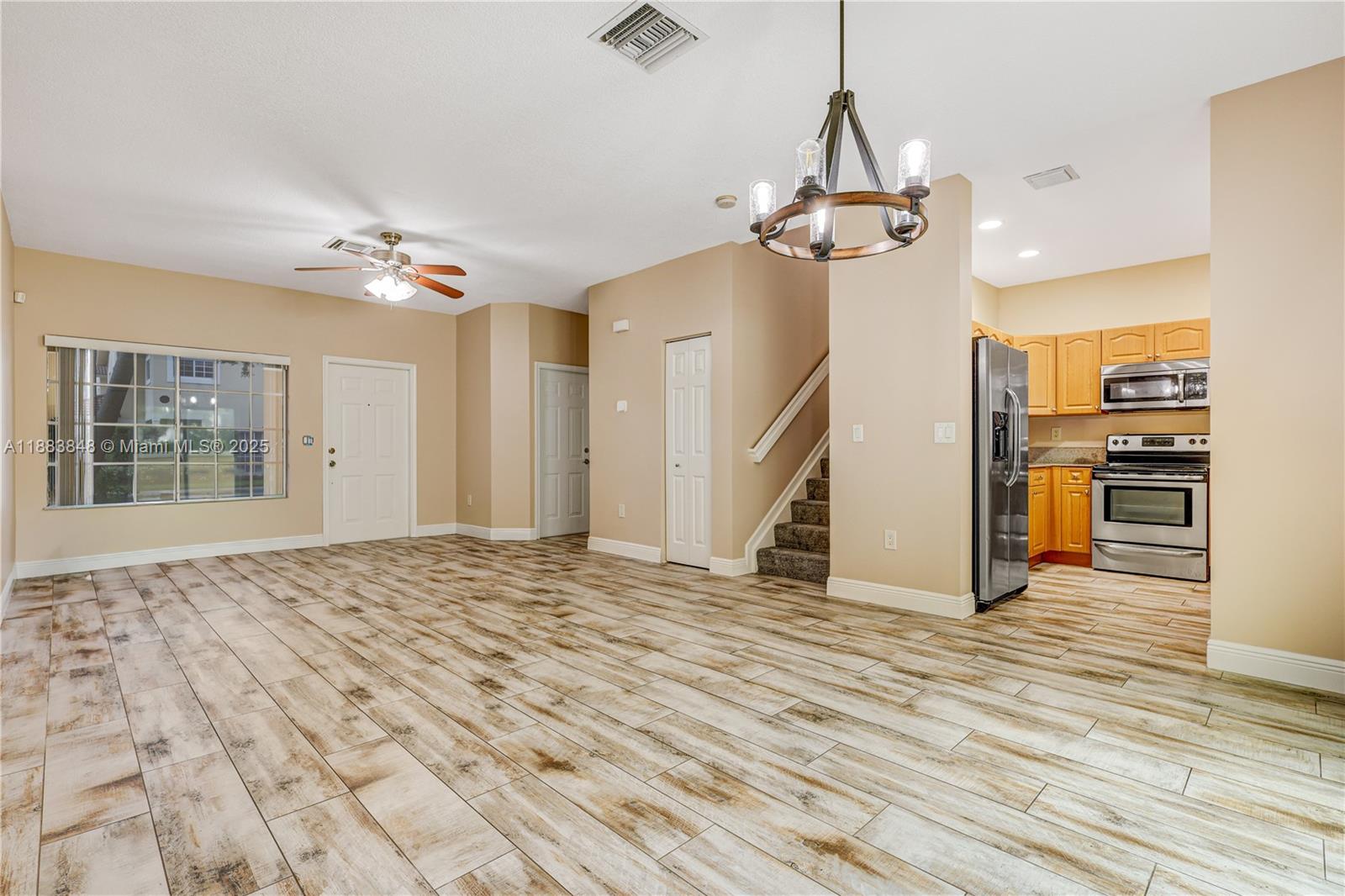 7627 East Stonecreek Circle Davie, FL 33024 - Photo 4 of 29 a view of a kitchen with wooden floor and a ceiling fan