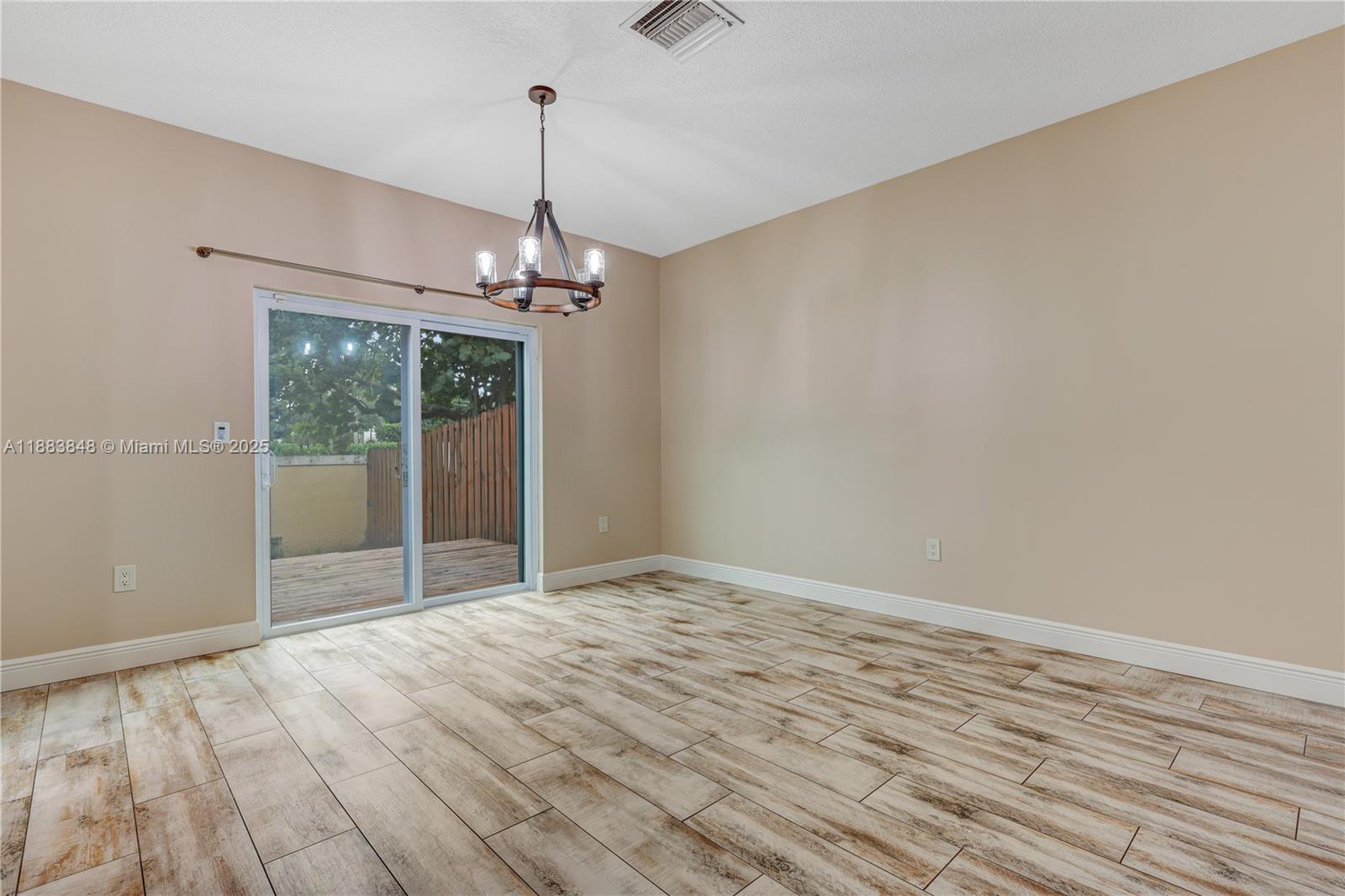 7627 East Stonecreek Circle Davie, FL 33024 - Photo 7 of 29 a view of a livingroom with a chandelier fan and wooden floor