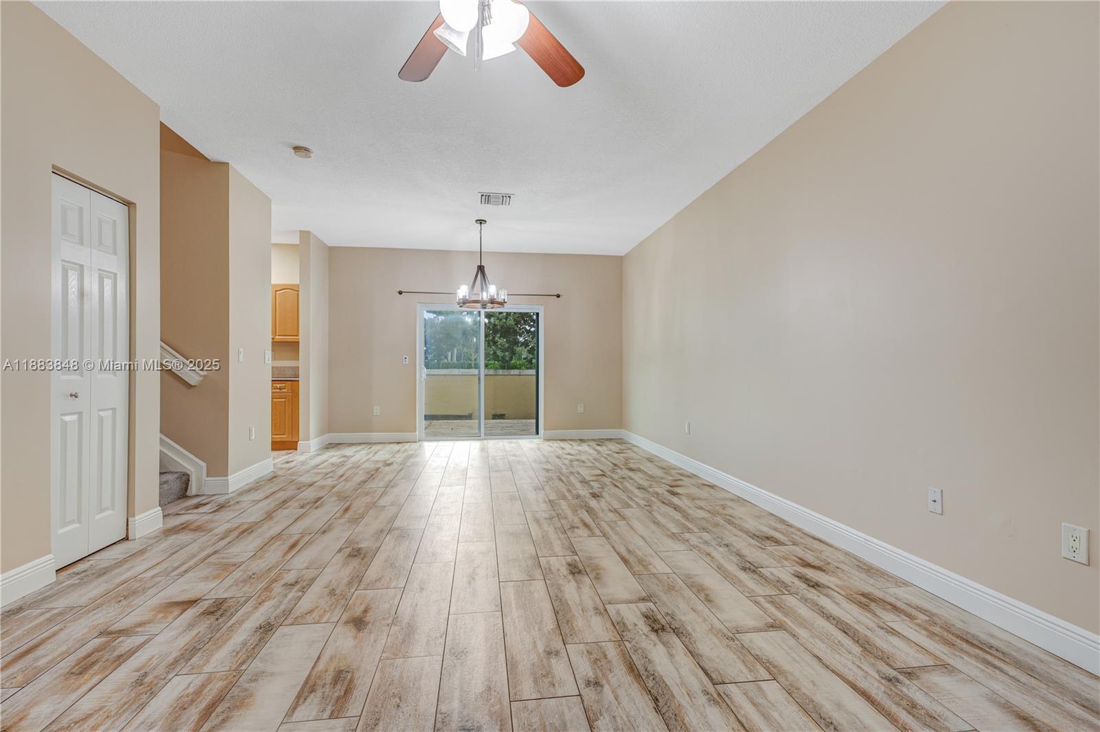 7627 East Stonecreek Circle Davie, FL 33024 - Photo 8 of 29 a view of an empty room with wooden floor and a window