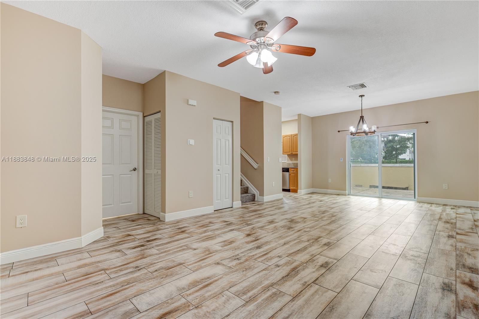 7627 East Stonecreek Circle Davie, FL 33024 - Photo 9 of 29 a view of an empty room with a chandelier fan