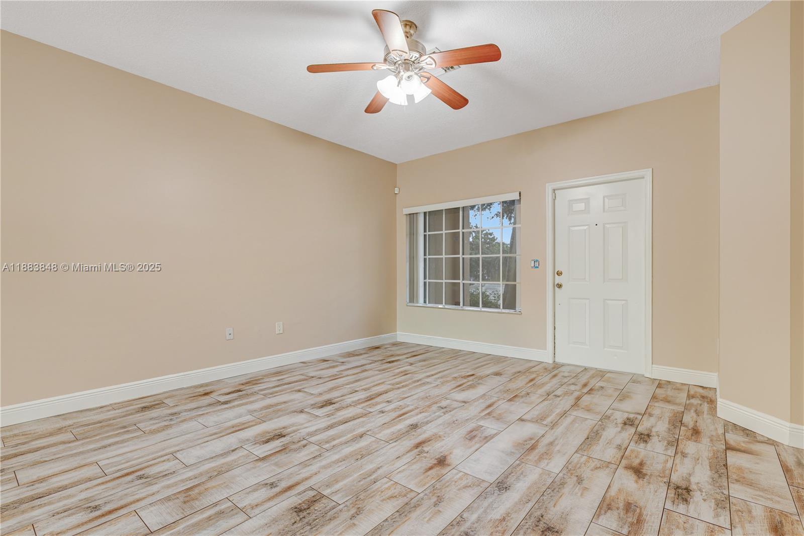 7627 East Stonecreek Circle Davie, FL 33024 - Photo 10 of 29 a view of empty room with wooden floor and fan
