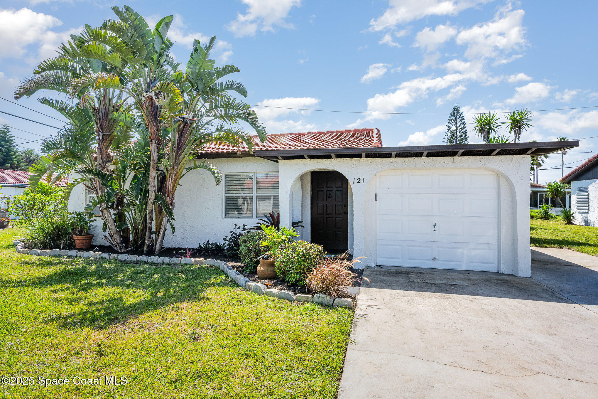 121 Del Flora Indialantic, FL 32903 - Photo 1 of 15 a front view of a house with a yard and garage