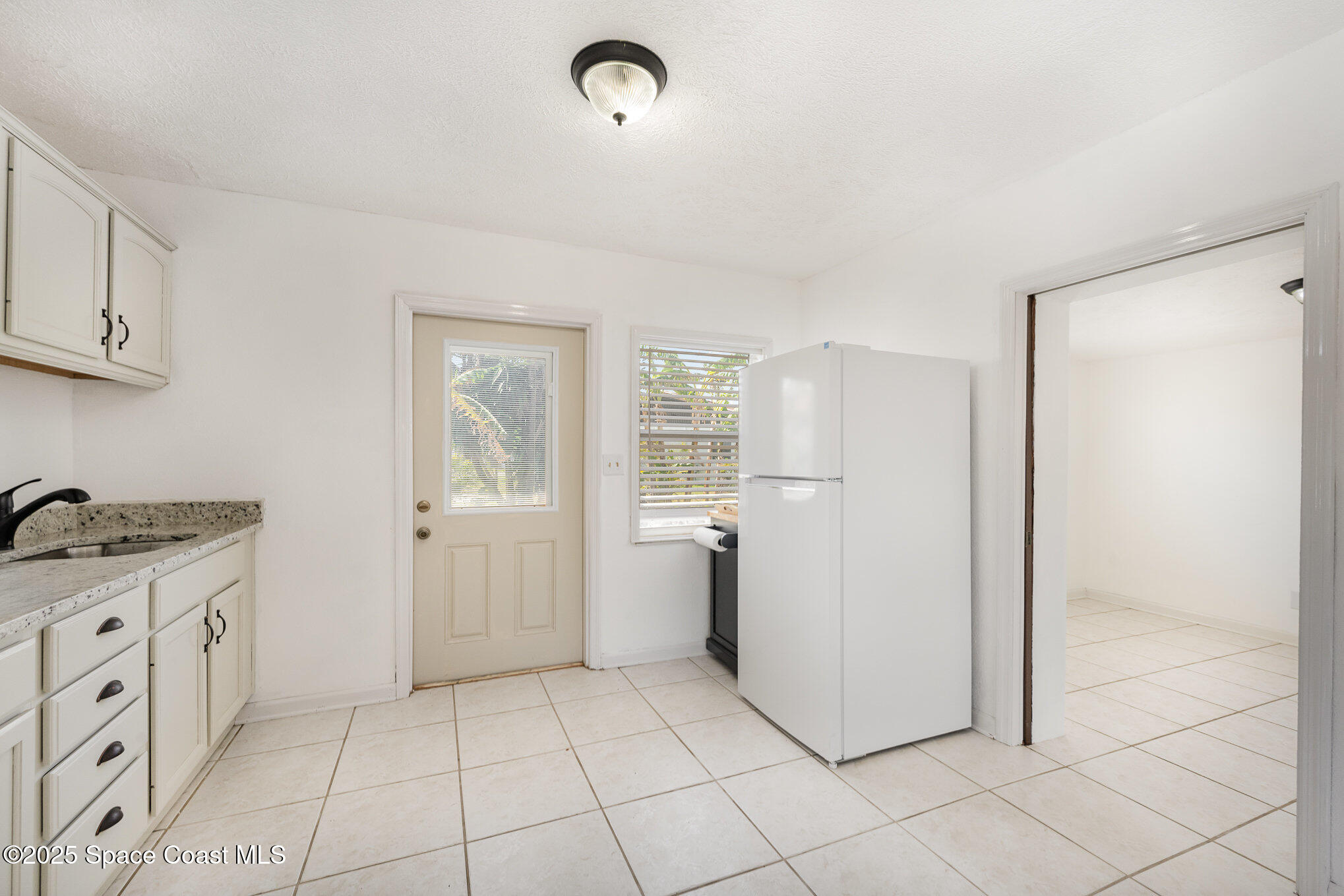 121 Del Flora Indialantic, FL 32903 - Photo 8 of 15 a kitchen with a stove a refrigerator and cabinets