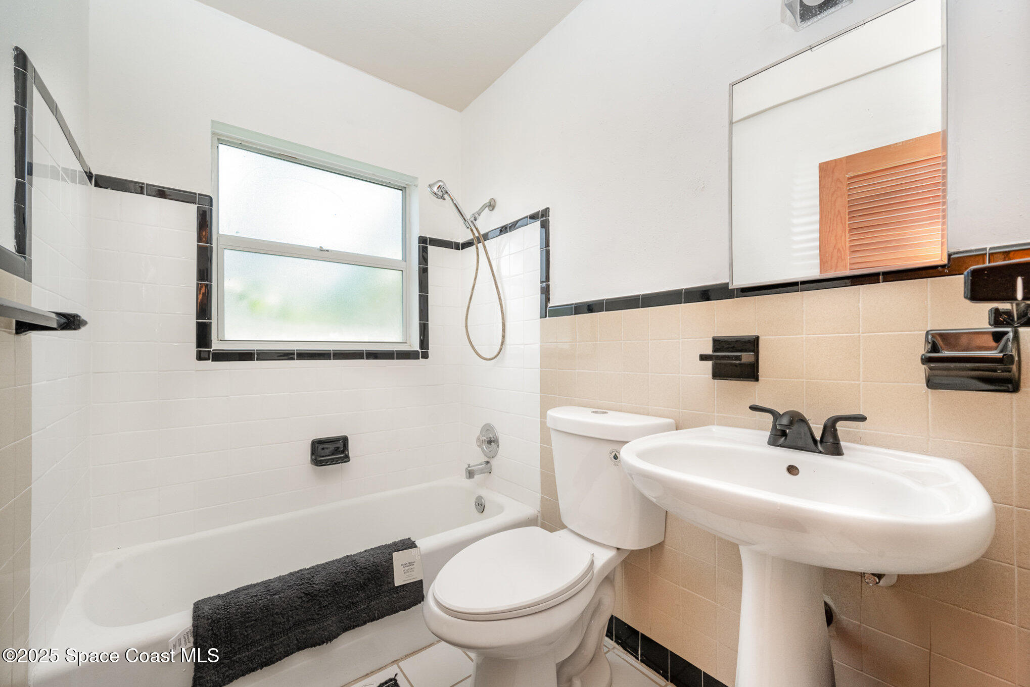 121 Del Flora Indialantic, FL 32903 - Photo 9 of 15 a bathroom with a sink a toilet and a mirror