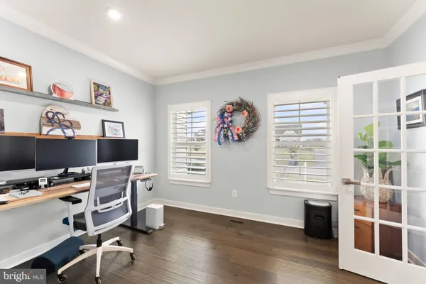 a living room with furniture and a dining table with kitchen view