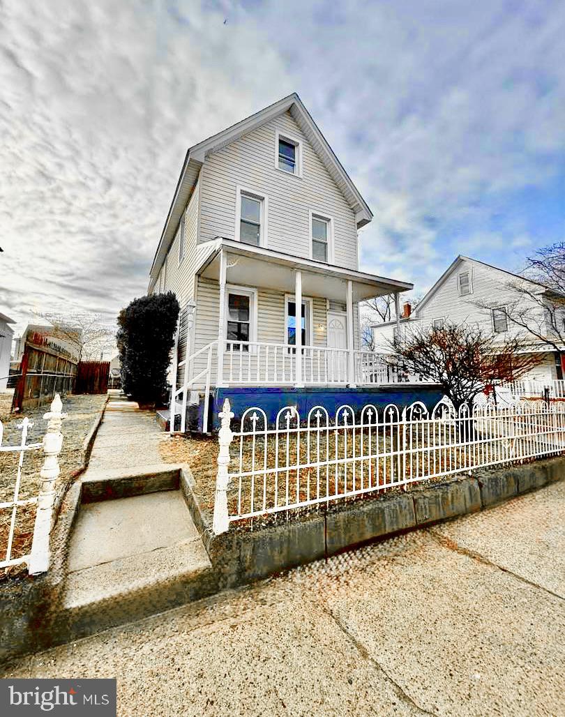 a view of a house with wooden fence