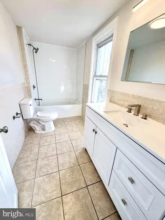 a bathroom with a sink a toilet a mirror and vanity