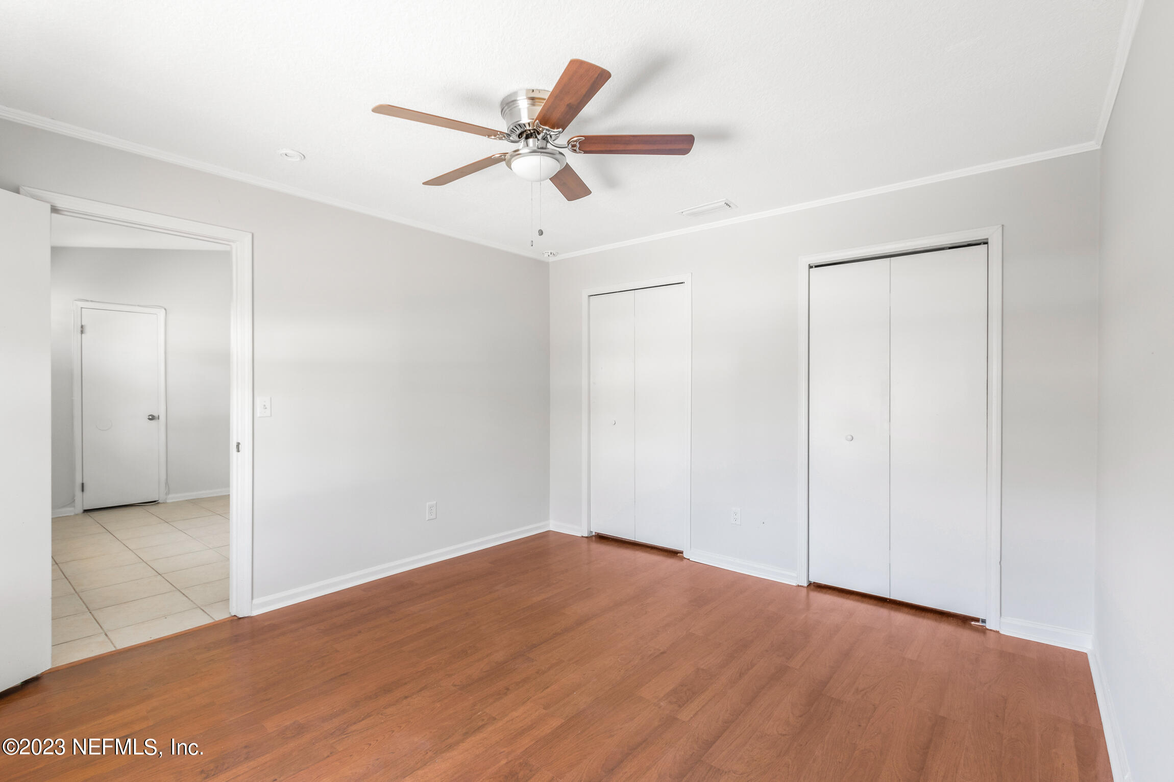 12770 Attrill Road Jacksonville, FL 32258 - Photo 17 of 38 a view of a big room with wooden floor and closet area