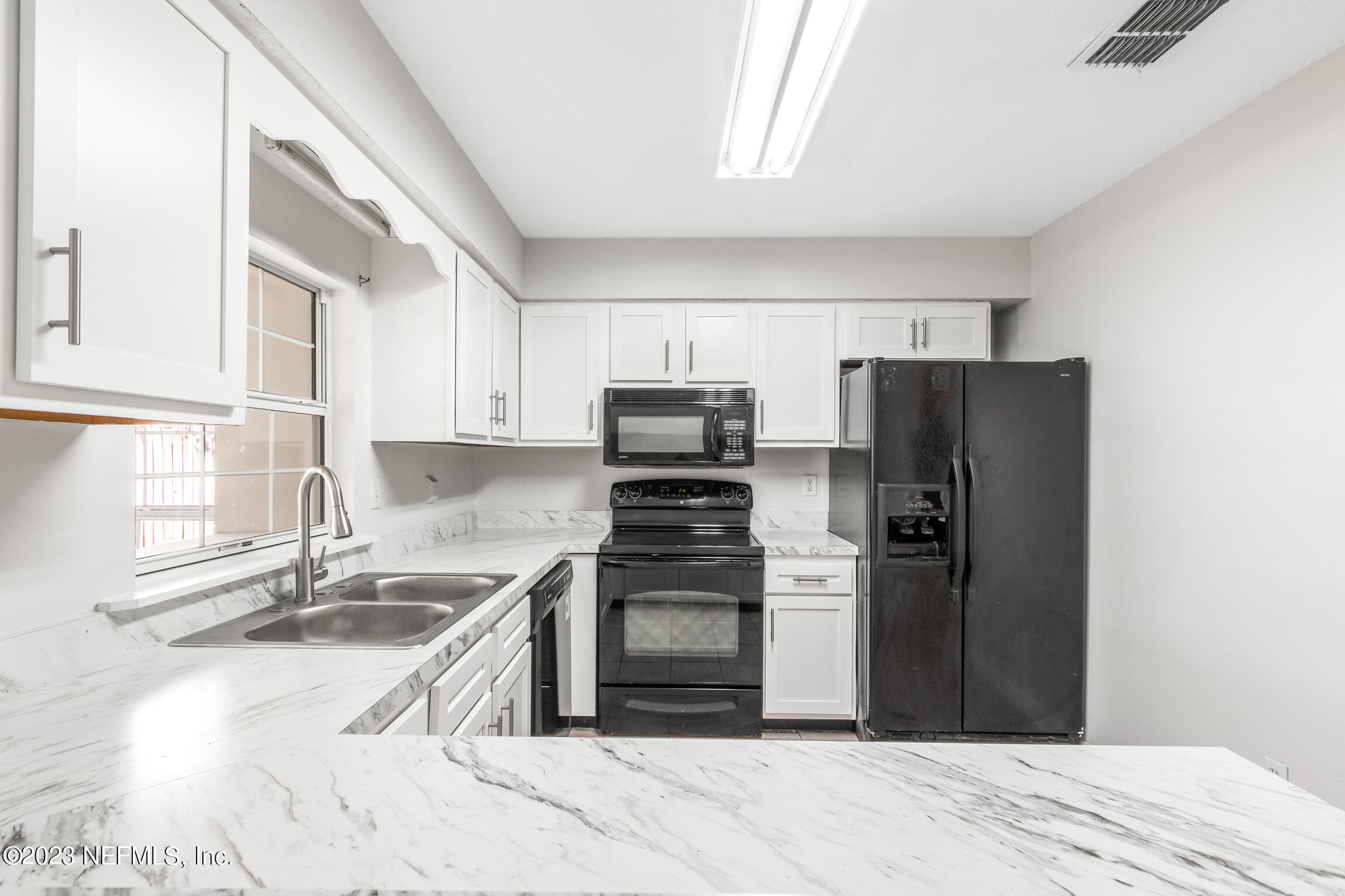 12770 Attrill Road Jacksonville, FL 32258 - Photo 25 of 38 a kitchen with granite countertop a refrigerator stove and sink